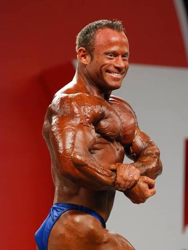 Jason Arntz posing on the Mr. Olympia stage